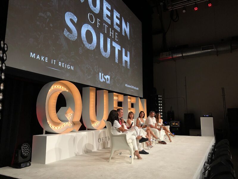 Cast panel on the white stage at the Queen of the South event for USA Network